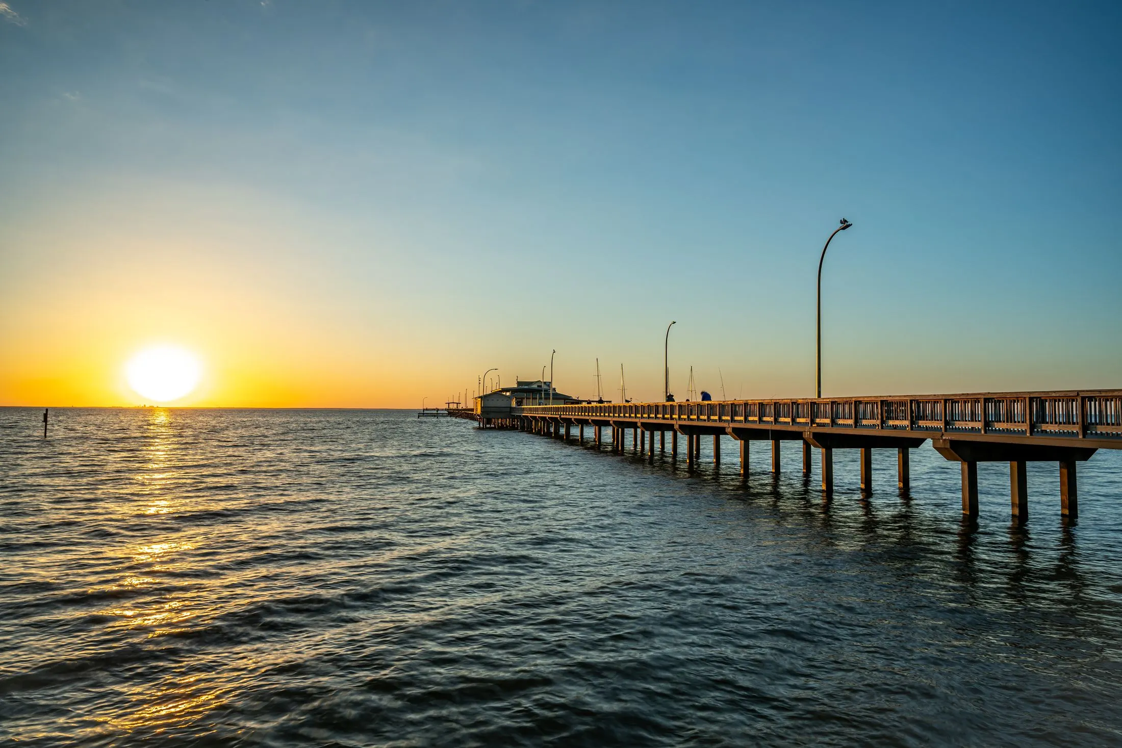Pier stretching into the lake at sunset